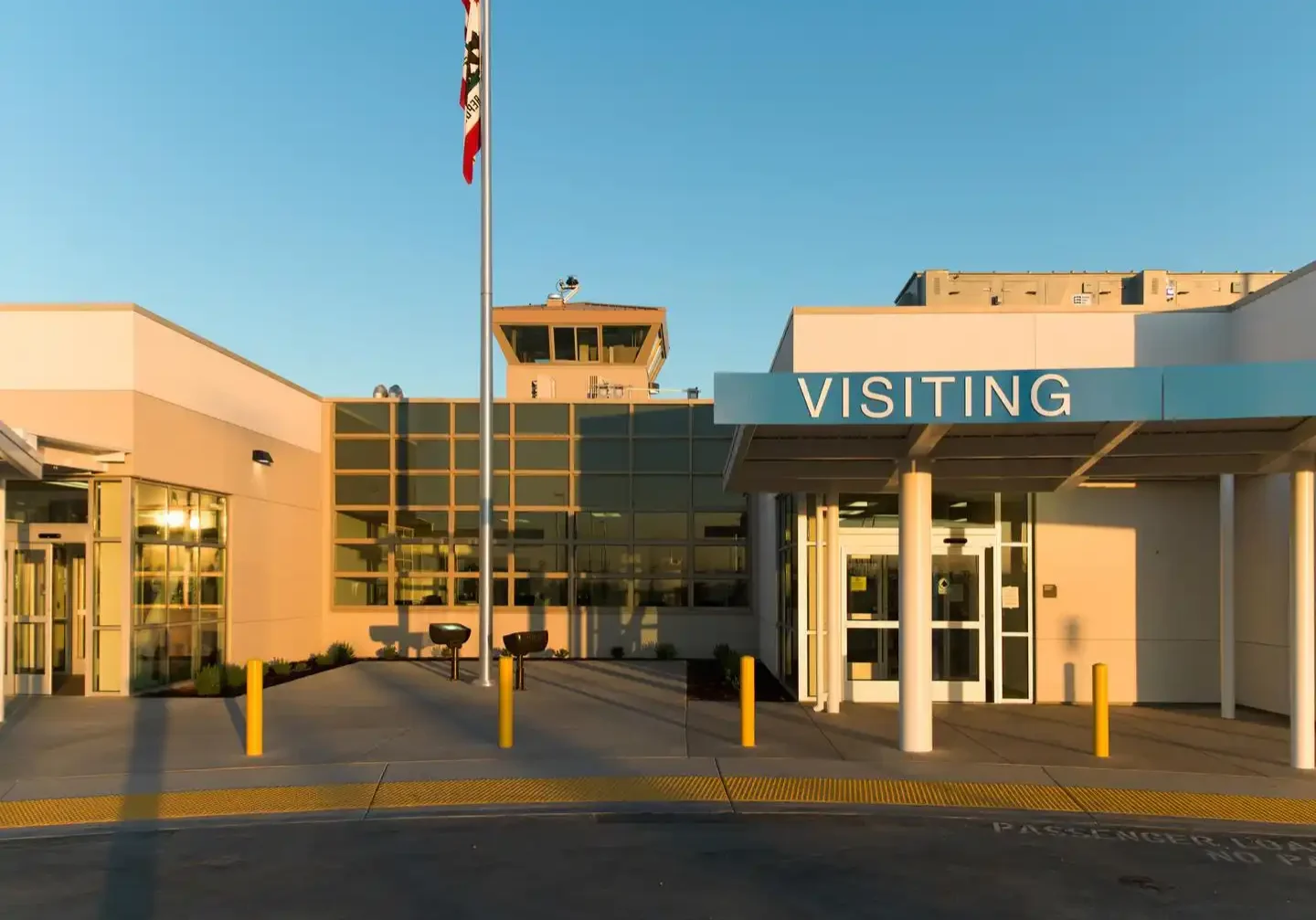 A building with a sign that says " visiting ".