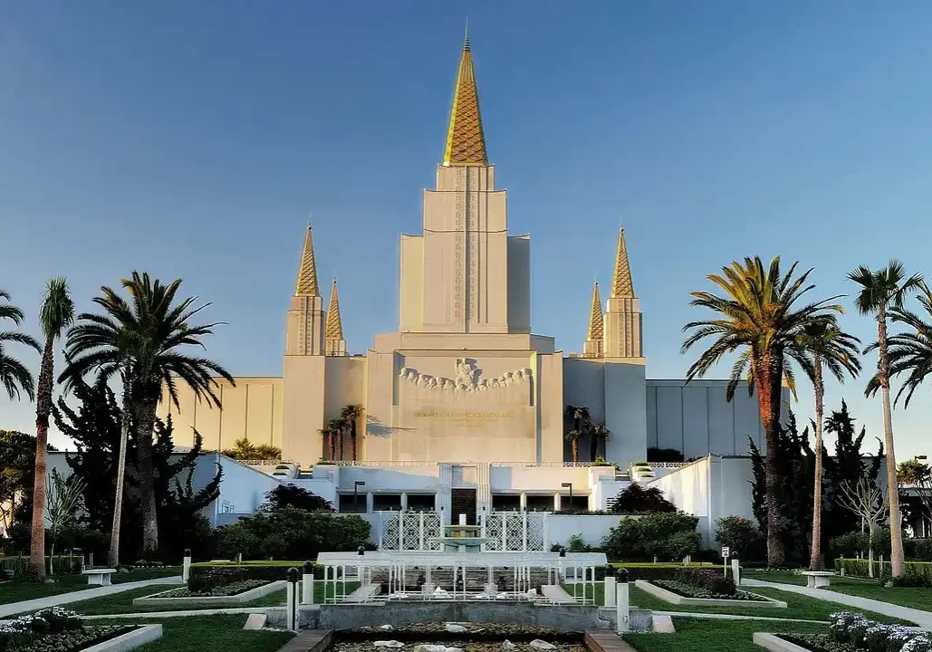 A large white building with many spires and trees